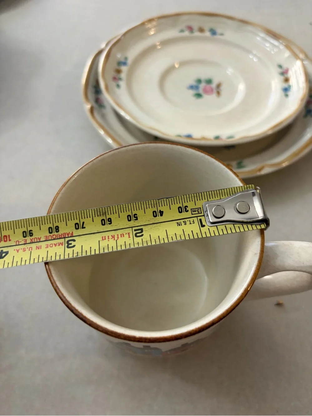 International Cream Ceramic Cup and Saucer Set with Hand-Painted Village Design
